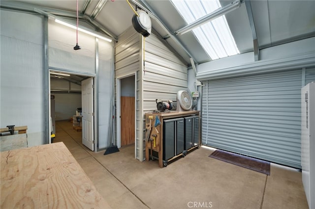 interior space featuring vaulted ceiling and concrete flooring