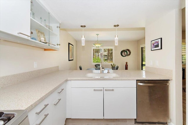 kitchen with dishwasher, white cabinetry, kitchen peninsula, and hanging light fixtures