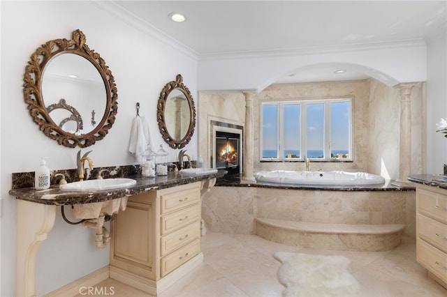 bathroom featuring tiled bath, vanity, and crown molding