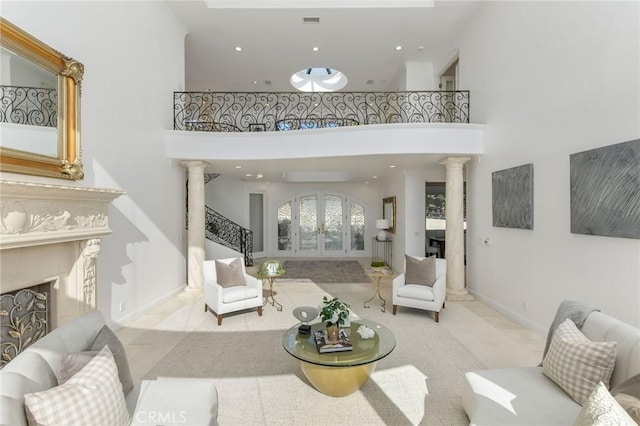 19 Marguerite Dr, Rancho Palos Verdes, CA 90275 - living area with decorative columns, a towering ceiling, a fireplace, stairway, and recessed lighting