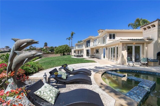 19 Marguerite Dr, Rancho Palos Verdes, CA 90275 - back of property featuring french doors, a patio, stucco siding, a yard, and a pool with connected hot tub