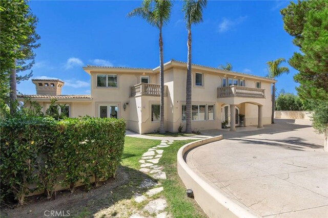 19 Marguerite Dr, Rancho Palos Verdes, CA 90275 - rear view of house featuring a balcony, stucco siding, and a tile roof