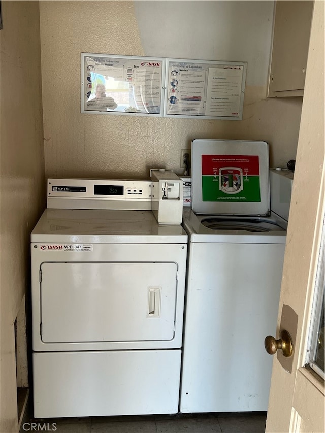 laundry area featuring washing machine and clothes dryer and tile patterned flooring