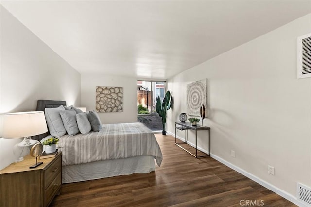 bedroom featuring dark wood-type flooring and access to outside