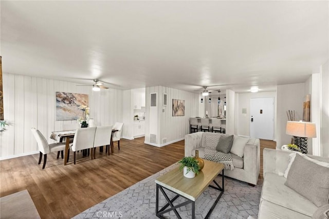 living room featuring ceiling fan and hardwood / wood-style floors