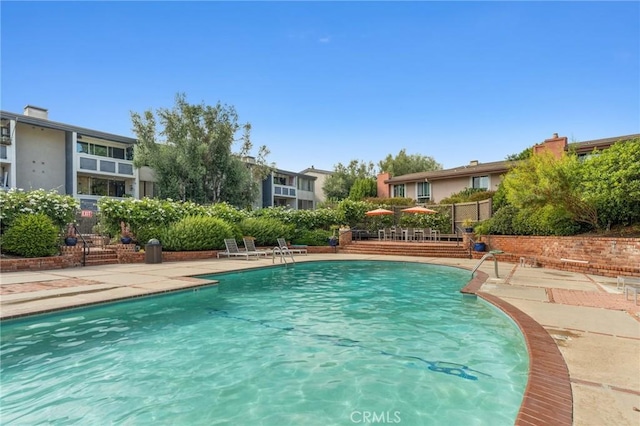 view of swimming pool with a patio