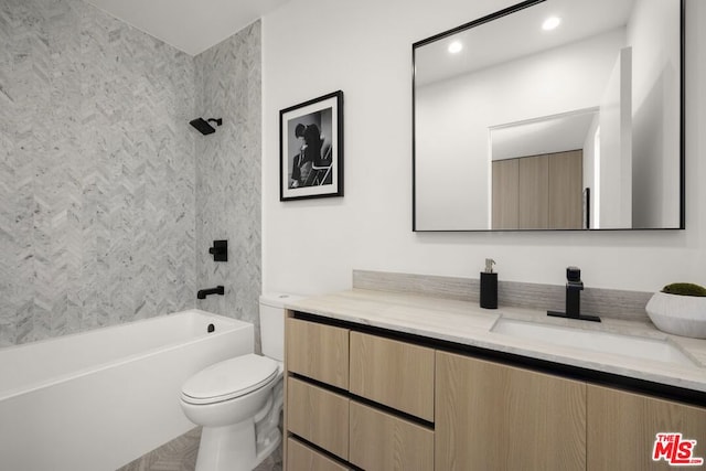 full bathroom with tiled shower / bath, vanity, and toilet