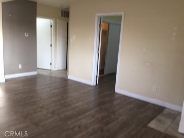 spare room featuring dark hardwood / wood-style floors