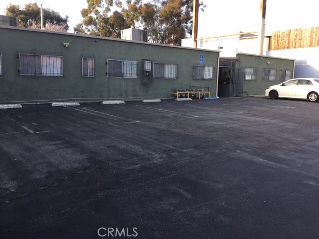 uncovered parking lot featuring fence