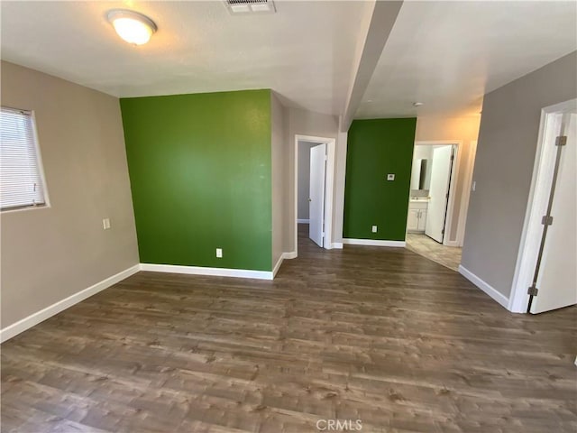 interior space featuring visible vents, baseboards, and wood finished floors