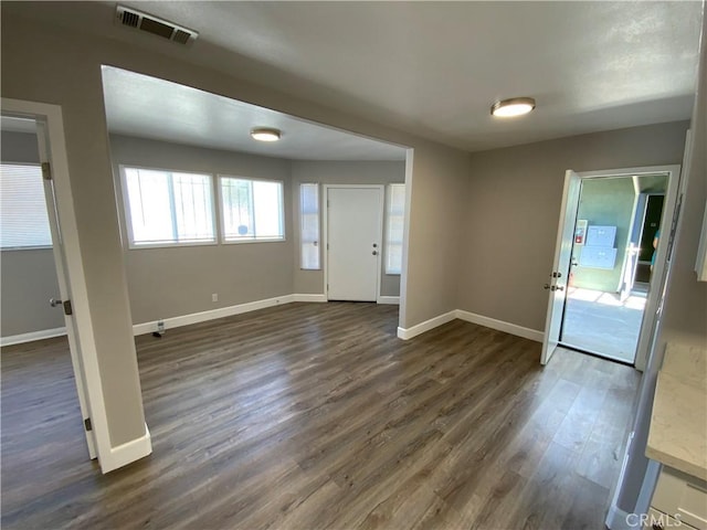 entrance foyer featuring baseboards, dark wood-style floors, and visible vents