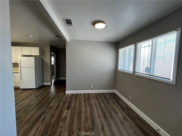 unfurnished room with dark hardwood / wood-style flooring