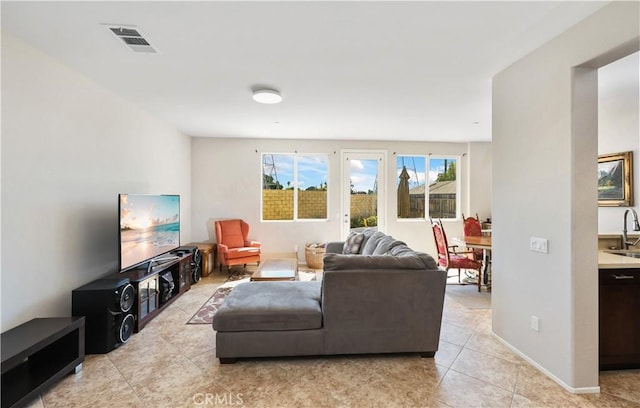 living room featuring light tile patterned floors and sink