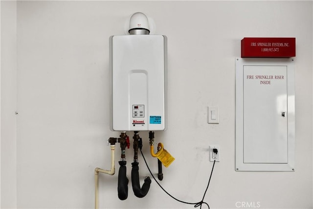 utility room with tankless water heater