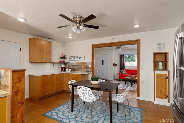 kitchen with hardwood / wood-style floors, stainless steel refrigerator, and ceiling fan