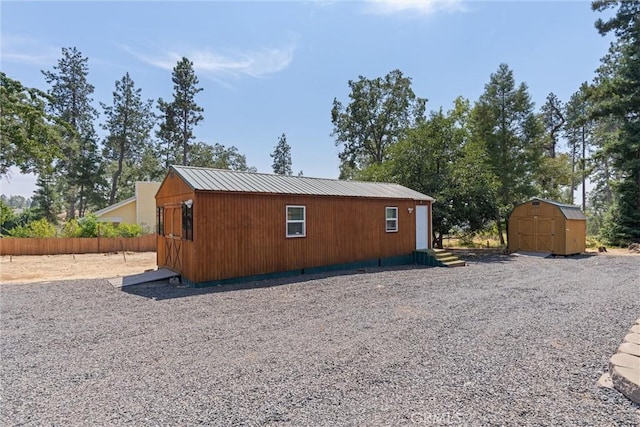 view of home's exterior featuring a storage unit