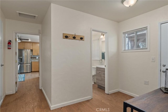 hallway with light hardwood / wood-style flooring