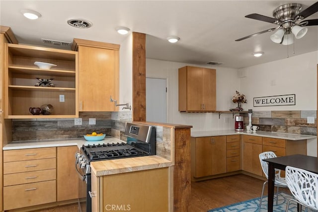 kitchen featuring gas range, light brown cabinets, tasteful backsplash, wooden counters, and wood-type flooring