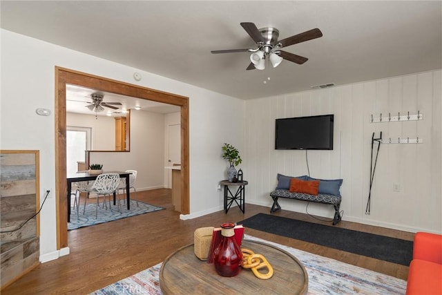 living room featuring wooden walls and hardwood / wood-style floors