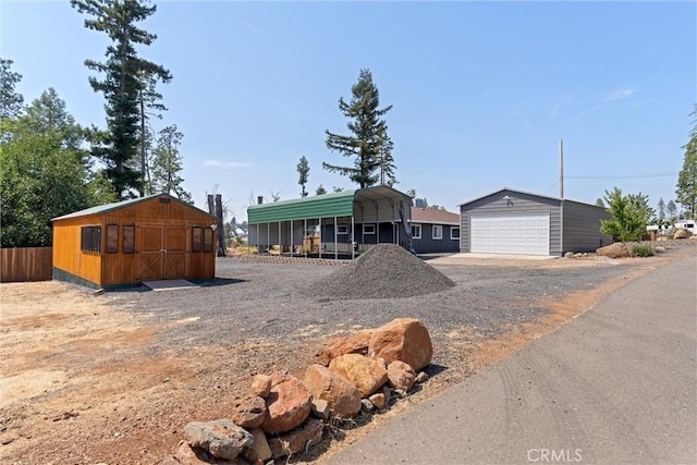 view of front of house featuring a carport and an outdoor structure