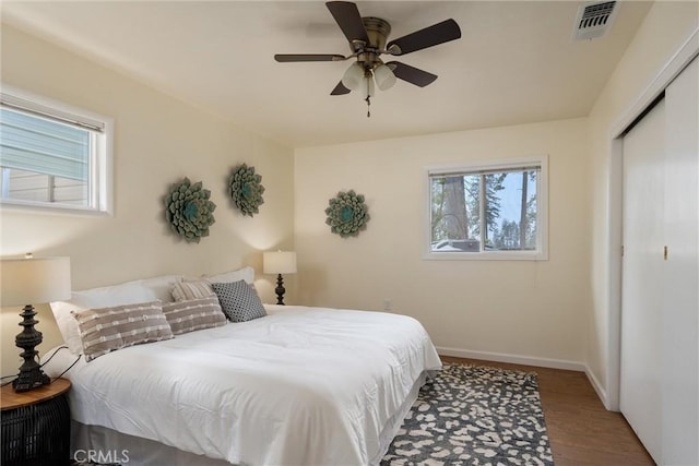 bedroom featuring ceiling fan, wood-type flooring, and a closet