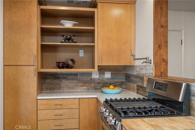 kitchen featuring wood counters, decorative backsplash, and stainless steel range with gas cooktop