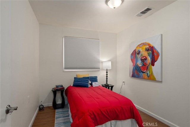 bedroom with hardwood / wood-style flooring