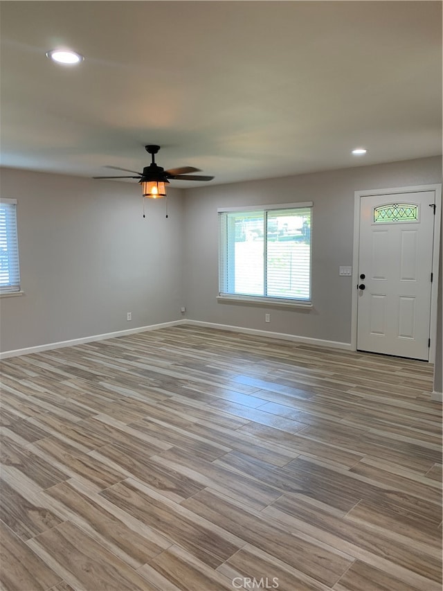 interior space with ceiling fan, light wood-style floors, recessed lighting, and baseboards