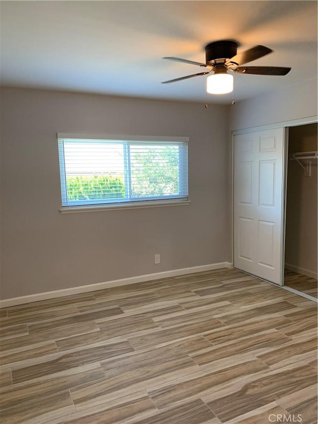 2431 12th St, Riverside, CA 92507 - unfurnished bedroom featuring multiple windows, a closet, baseboards, and light wood-type flooring