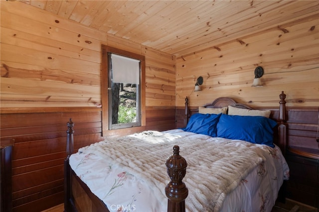 bedroom with wooden walls and wooden ceiling