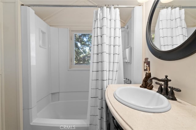 bathroom featuring vanity and shower / bathtub combination with curtain