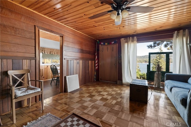 interior space with wood ceiling, wood walls, and a wealth of natural light