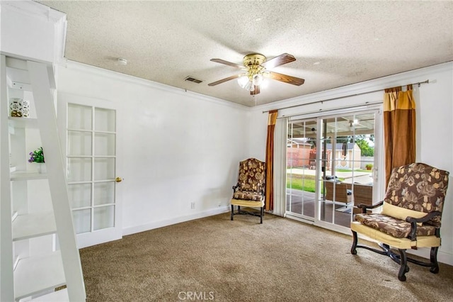 living area with french doors, a textured ceiling, ceiling fan, crown molding, and carpet floors