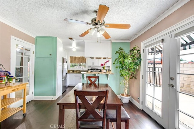 dining area with a textured ceiling, ceiling fan, dark hardwood / wood-style flooring, and crown molding