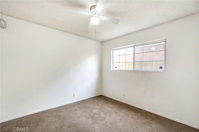 empty room featuring carpet flooring, ceiling fan, and a textured ceiling