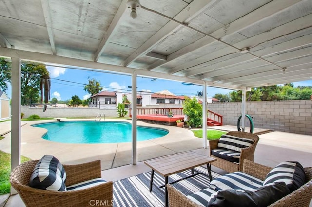 view of swimming pool featuring outdoor lounge area, a patio area, and a wooden deck