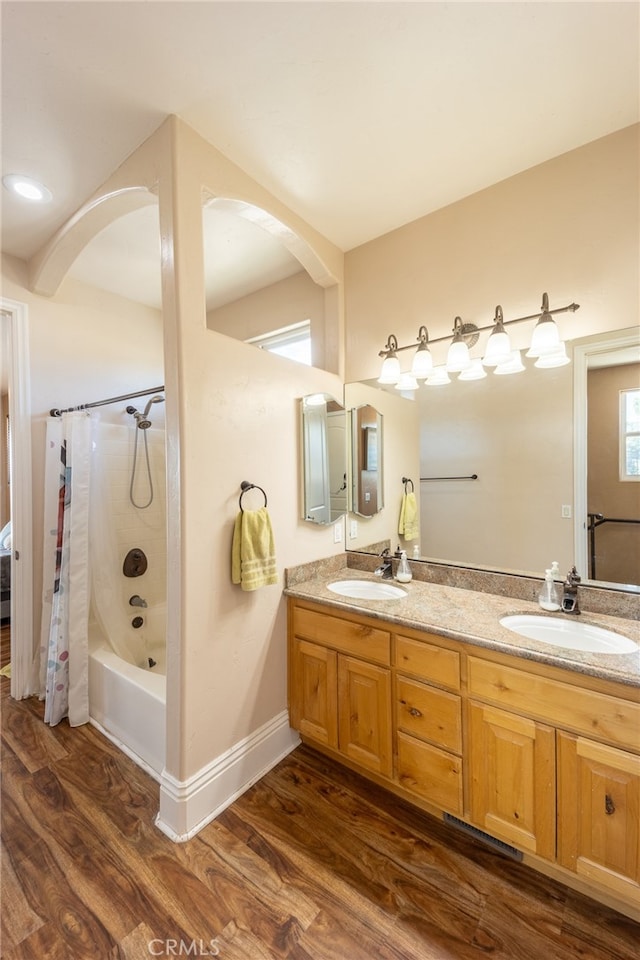 bathroom with shower / bathtub combination with curtain, vanity, and hardwood / wood-style flooring