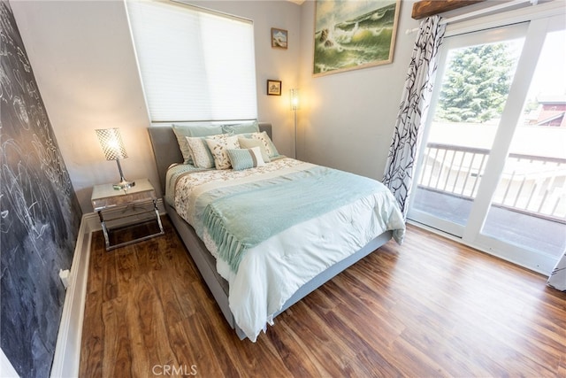 bedroom with hardwood / wood-style floors and access to outside