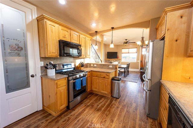 kitchen featuring ceiling fan, pendant lighting, kitchen peninsula, black appliances, and dark hardwood / wood-style flooring