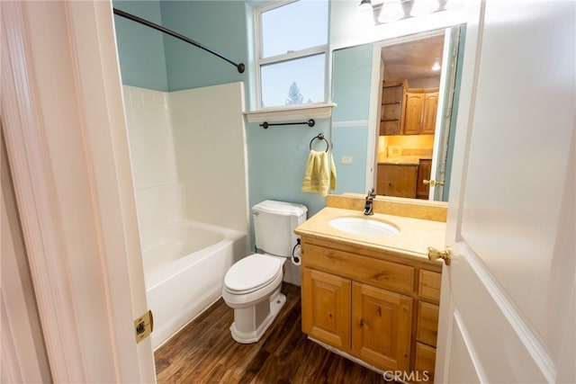 full bathroom featuring wood-type flooring, shower / bathtub combination, vanity, and toilet