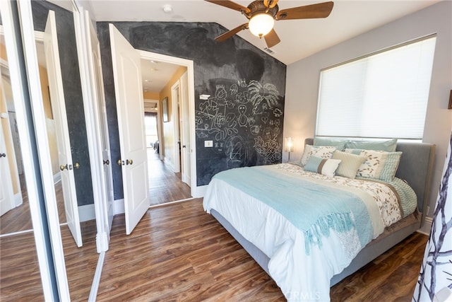 bedroom featuring lofted ceiling, ceiling fan, and dark hardwood / wood-style floors