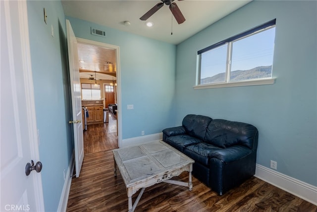 sitting room featuring ceiling fan and dark wood-type flooring