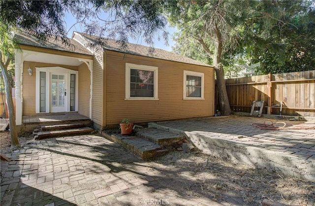 back of property with a patio and french doors