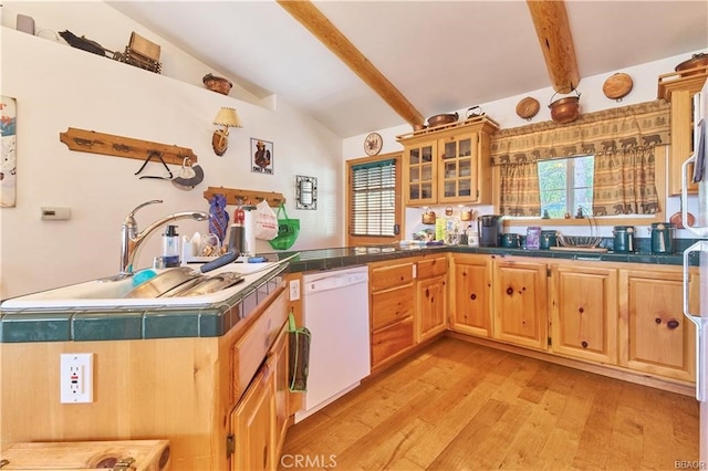 kitchen featuring light wood finished floors, dishwasher, lofted ceiling with beams, glass insert cabinets, and a sink