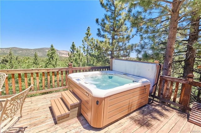 wooden terrace with a mountain view and a hot tub