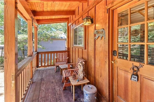 sunroom / solarium featuring wooden ceiling and beam ceiling