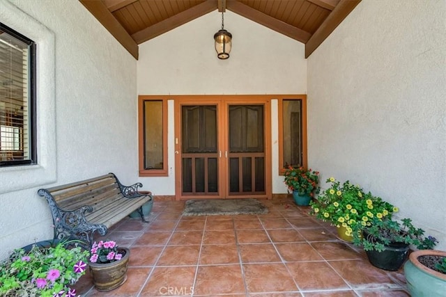 view of exterior entry featuring a patio area