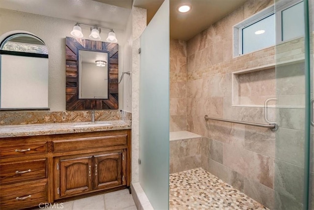 bathroom with vanity and a shower with shower door