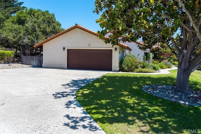 view of front facade with a garage and a front lawn