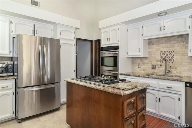 kitchen with white cabinetry, appliances with stainless steel finishes, and sink